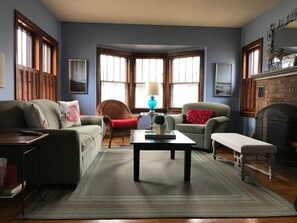 Cozy living room with fireplace and flat screen TV.