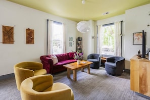 The living room of the upper unit has a couch and swivel chairs to sit in.
