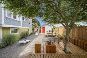 Side yard complete with kids play structures, picnic table, and corn hole!