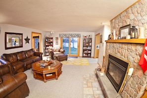 Big, luxurious leather furniture in living room. Cozy fireplace.