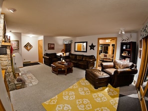 Comfy, formal living room with fireplace.