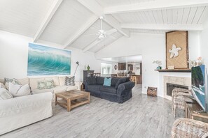 View of spacious living, dining and kitchen areas from the front balcony's sliding glass door.
                