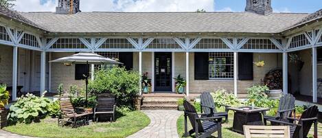 Exterior Courtyard, Adirondack chairs, shade umbrella and propane fire table