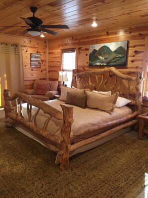 King bed in master with private deck overlooking the river and mountain view. TV
