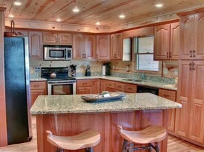 Full kitchen with granite countertops and stainless steel appliances