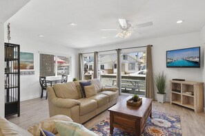 Living and dining areas look out to front ocean view patio, with easy access through sliding glass doors. Ceiling fans throughout.
                