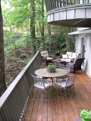Front porch/deck with comfortable seating and dining. Gas grill (not pictured).