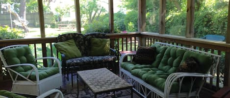 Screened in porch with sofa, loveseat and chairs