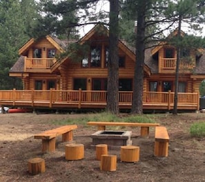 View of the river side of the cabin and fire pit.