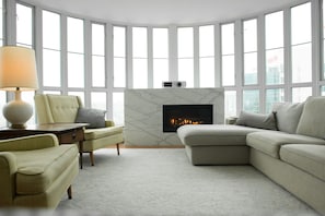 Living room with gas fireplace and film projector. 