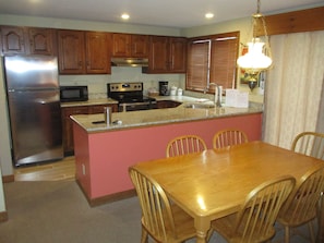 Looking into kitchen from dining room. All cooking utensils provided. 