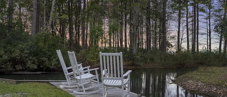 Rocking chairs overlooking the open lake from the backyard.