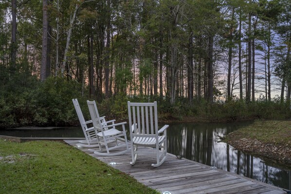 Rocking chairs overlooking the open lake from the backyard.