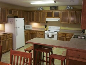 Upstairs kitchen is fully equipped with extra seating at the bar