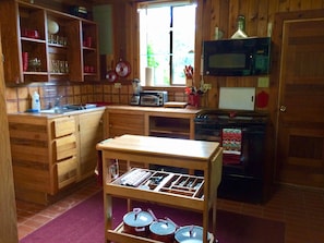 Kitchen is fully equipped, including a full-size stove, fridge, and microwave.