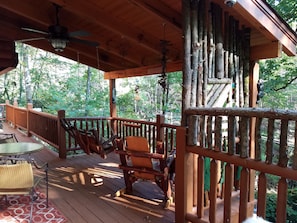 Kickback in the oversized log rocker or swing overlooking an ever-flowing cree