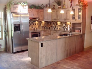 Here's your ADA kitchen with granite counters, hickory cabinets and stocked!