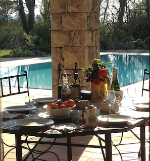 Dining area overlooking pool, forest and mountains