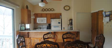 View from the living area looking back toward the door and kitchen. Deck to left