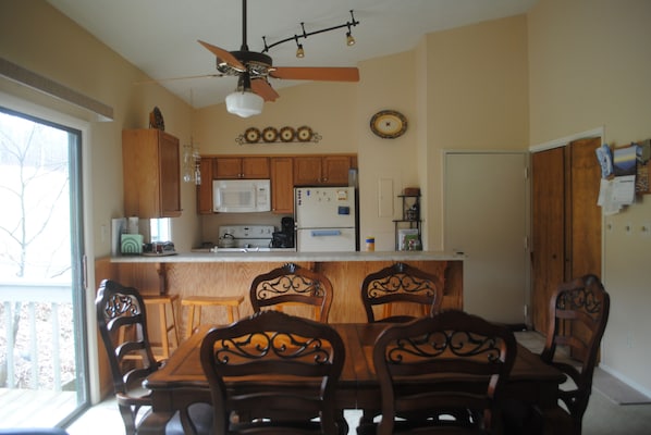 View from the living area looking back toward the door and kitchen. Deck to left