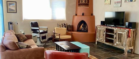 The living room features a cozy kiva fireplace with gas logs.