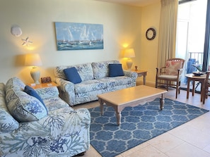 Living area with queen sofa sleeper, love seat and two side chairs.