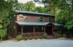 Front porch with twig, cozy rockers. Watch kids on the playground!