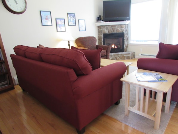 Sunny and bright living room with slope views. Sofa, loveseat and club chair. 