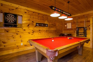 Full size pool table, dart board and pub table offer different gaming options