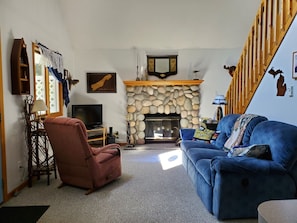 Living room with functional wood burning fireplace.