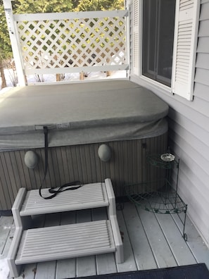 hot tub on covered porch open year round