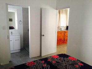 The Bedroom with ensuite shower, vanity and toilet