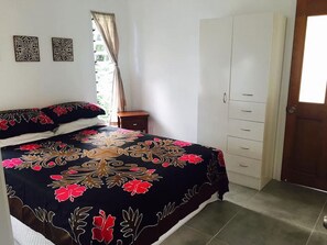 Queen size bed, wardrobe and back door leading to laundry and carport
