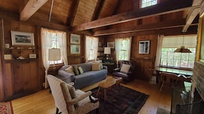 Main living area with knotty pine and exposed beams