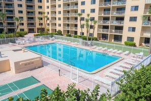 Sparkling resort-style heated pool surrounded by lush landscaping.
