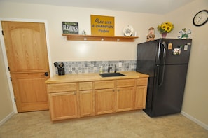 Guest kitchen.  Full size refrigerator, 2 cooking hot plates and kitchen ware