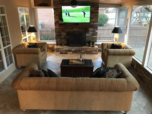 Screened in porch with fireplace. Perfect for entertainment.
