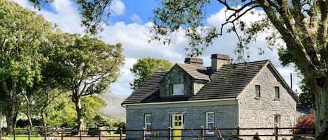 Bayfield House taken from the field in front with the Burren Hills behind