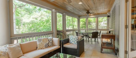 Huge Rear Screened Porch with Plenty of Seating and Beautiful Water Views.