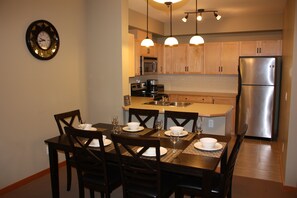 Fully equipped kitchen with 6 seater dining area.