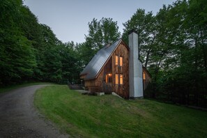 View of the house as you come up the drive at dusk.