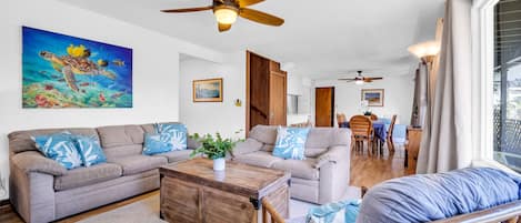 Spacious living room with ocean breezes and tropical garden view 