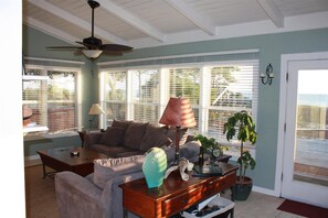 Living area with sleeper sofa, ocean views in background.