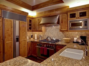 Kitchen features beautiful granite and custom cabinetry