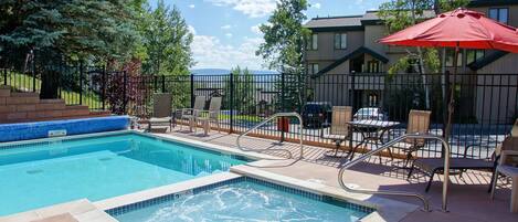 Pool and hot tub with the condo in the background