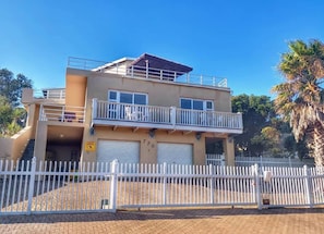 front of the house with parking area inside the fence