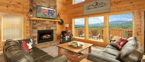 Cozy & inviting 27' high stacked-stone gas fireplace w/wall of windows