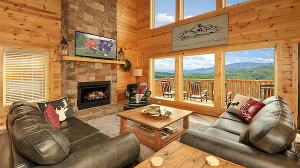 Cozy & inviting 27' high stacked-stone gas fireplace w/wall of windows