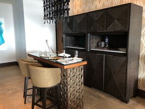 Bar area with wine fridge and crystal bar glasses.