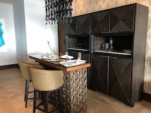 Bar area with wine fridge and crystal bar glasses.